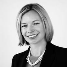 A woman with short hair wearing a black jacket.